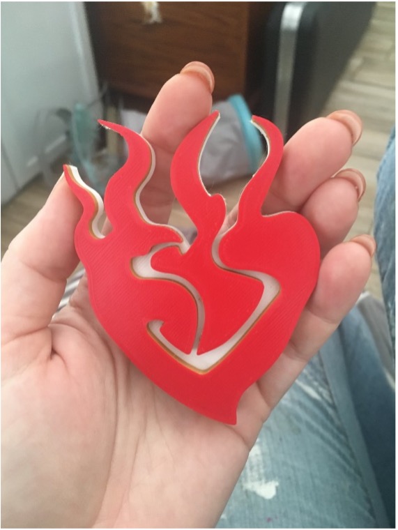 Red Plastic 3D printed RWBY logo to be used as the mold for the belt buckle