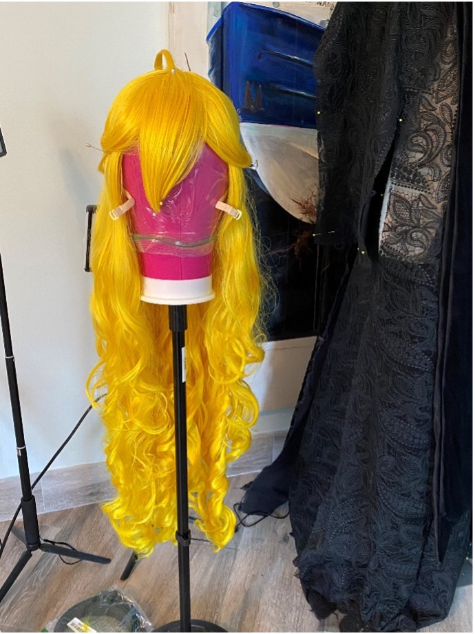 Front view of finished wig on wig stand