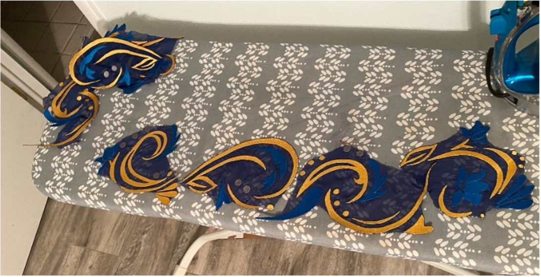 Appliqués laid out in their order of installation on the ironing board.